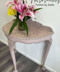Dixie Belle Paint Soft Pink Chalk Mineral Paint is the perfect paint for any DIY project! A half-moon hallway table painted in soft pink chalk mineral paint and is accompanied with a stencil on the top. This hallway table is staged with flowers on the top of the table.