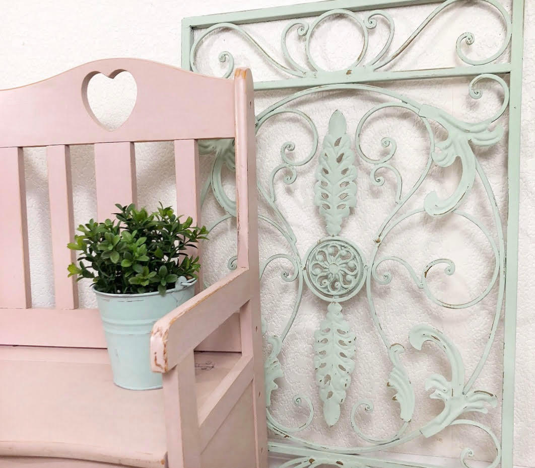 Dixie Belle Paint Soft Pink Chalk Mineral Paint is the perfect paint for any DIY project! A wooden chair with a heart of the top middle of the back and the chair is painted in soft pink chalk mineral paint with a distressed look on the edges.