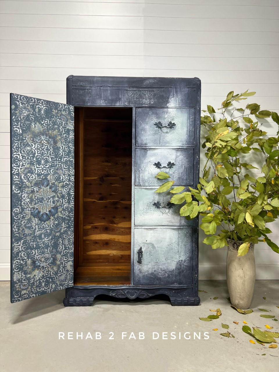Dixie Belle Paint Stormy Seas Chalk Mineral Paint is the perfect paint for any DIY project!
Wardrobe painted in Stormy Seas Chalk Mineral Paint with blended white on the drawers. Wardrobe door is played open with distressed pattern inside door.  Staged with a vase and greenery.