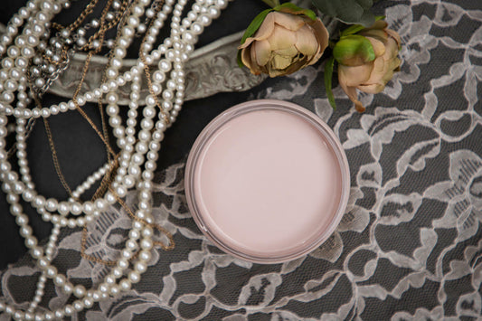 Dixie Belle Paint Tea Rose Chalk Mineral Paint is the perfect paint for any DIY project!
Opened container of Tea Rose Chalk Mineral Paint staged with pearls, lace cloth, and roses.
