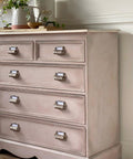 Dixie Belle Paint Tea Rose Chalk Mineral Paint is the perfect paint for any DIY project!
Image of dresser painted in Tea Rose Chalk Mineral Paint with antique hardware. Staged with white flower vases on the dresser.