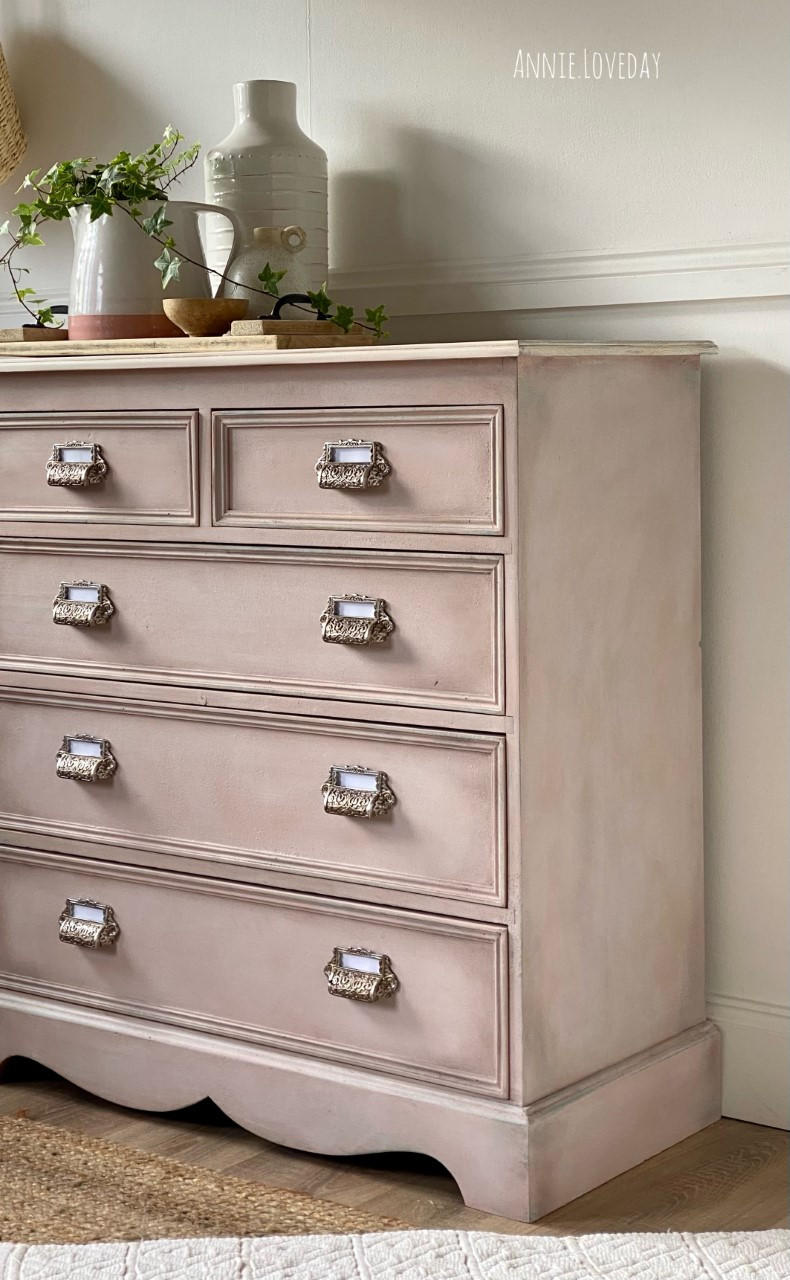 Dixie Belle Paint Tea Rose Chalk Mineral Paint is the perfect paint for any DIY project!
Image of dresser painted in Tea Rose Chalk Mineral Paint with antique hardware. Staged with white flower vases on the dresser.
