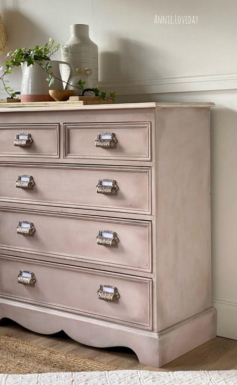 Dixie Belle Paint Tea Rose Chalk Mineral Paint is the perfect paint for any DIY project!
Image of dresser painted in Tea Rose Chalk Mineral Paint with antique hardware. Staged with white flower vases on the dresser.
