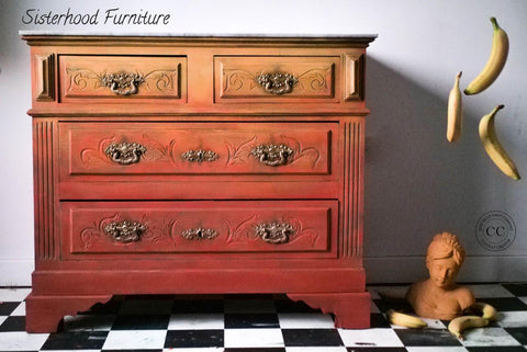 Dixie Belle Paint Terracotta Chalk Mineral Paint painted furniture piece, three drawers with an ombre effect.  Three bananas are floating to the right of the painted furniture piece