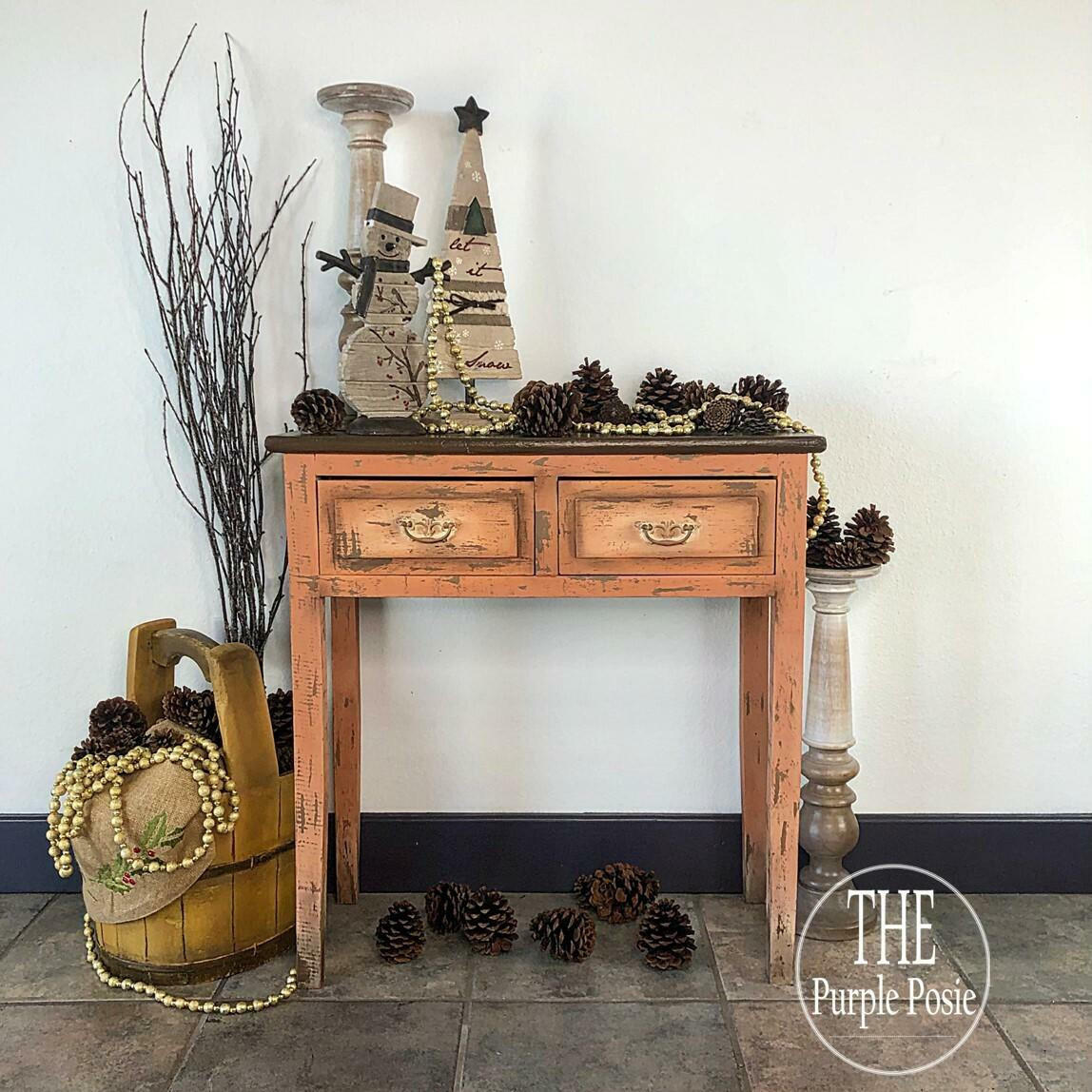 Dixie Belle Paint Terracotta Chalk Mineral Paint is the perfect paint for any DIY project!  A brown chalk painted and distressed hallway table with pine cones, baskets and winter decorations.