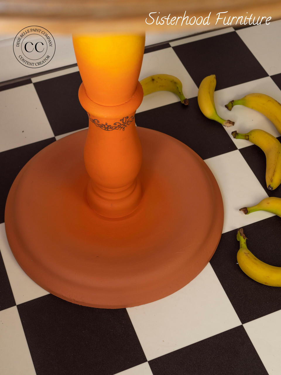 Dixie Belle Paint Terracotta Chalk Mineral Paint closed up of the leg of the dresser with bananas on the ground to the right of it.