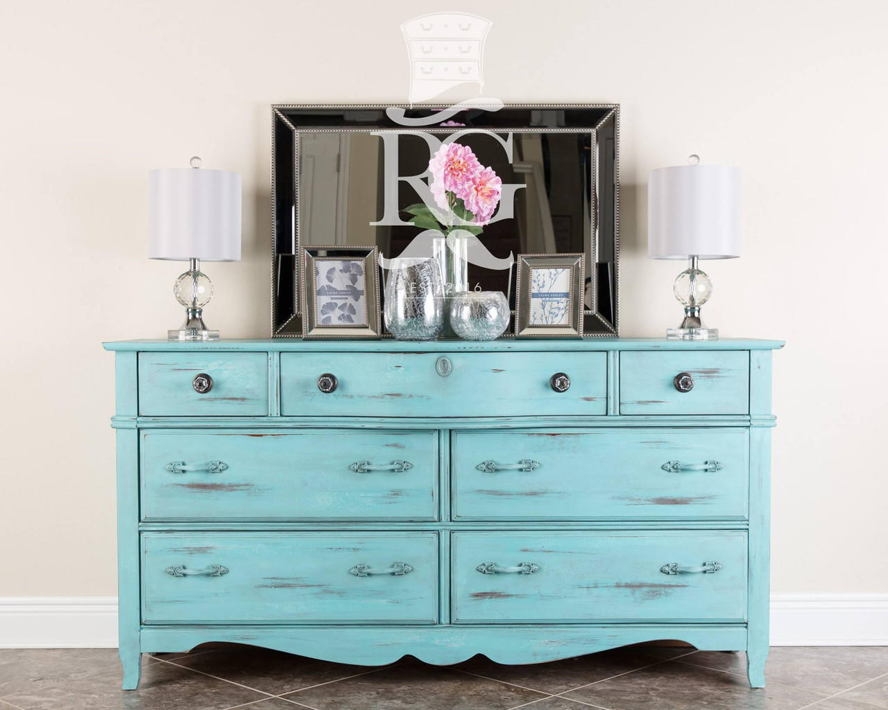 Dixie Belle Paint The Gulf Chalk Mineral Paint dresser that is distressed and has two white lamps on the top