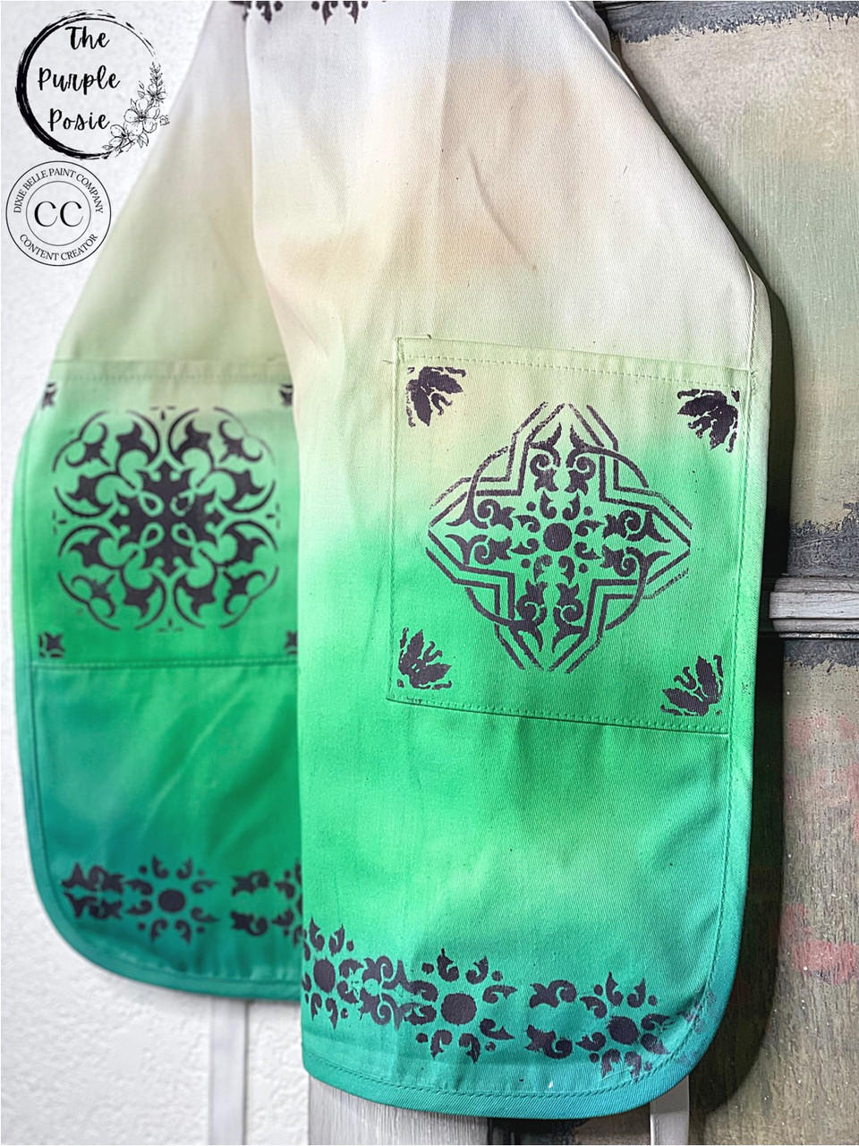 Dixie Belle Paint Tree Frog Green Chalk Mineral Paint is the perfect paint for any DIY project! A white apron with green chalk paint and a brown chalk painted stenciled pattern