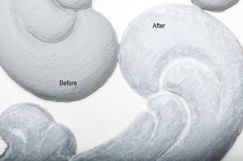 Dixie Belle Paint Whitewash Glaze. Two pieces of white chalk painted decorative appliques, one without glaze and one with glaze applied, with a white background.