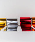 Four rolls of Dixie Shine, of each color. From left to right: gold, silver, red, and copper.