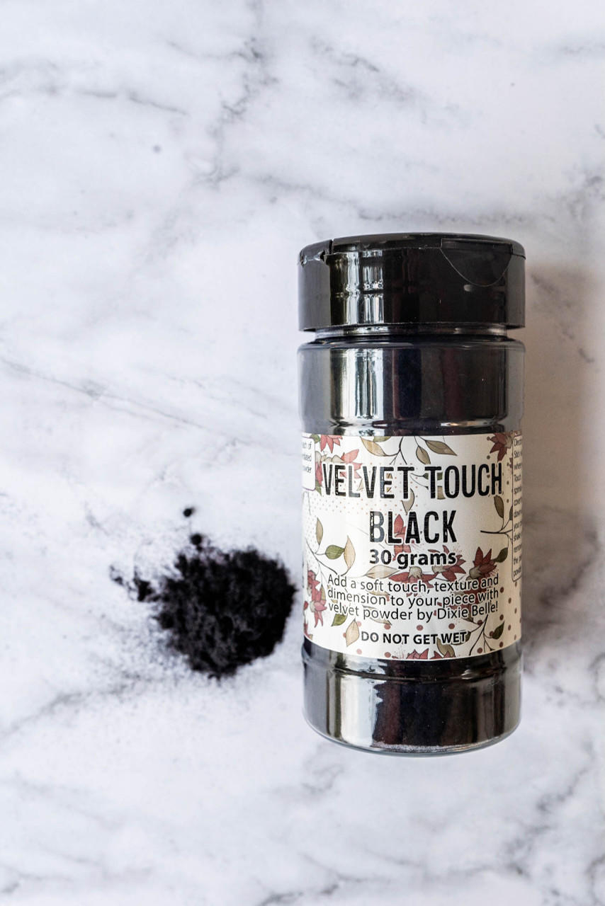 Black Velvet Touch bottle with a small pile of the velvet powder next to it.
