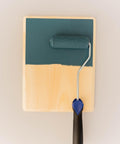 Smooth Roller being used on a wood board with a greenish blue paint.