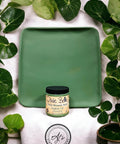 Wooden tray painted with English Ivy Chalk Mineral Paint. Staged with green leaves surrounding the wooden tray and paint jar.