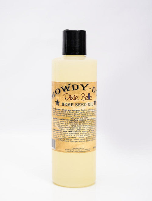 A plastic bottle of Dixie Belle Howdy-Do Hemp Seed Oil with a black cap and a beige label, displayed against a white background.
