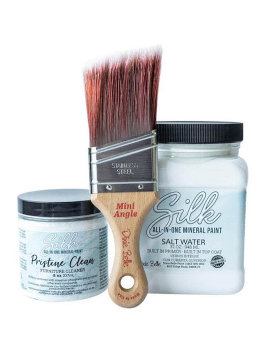Kitchen Starter Bundle is perfect for a DIY kitchen makeover! close up image that has the Mini angle Brush in the center on the left has an 8oz container of Pristine Clean from the Silk All-in-one Paint with a 32oz Silk All-in-One Mineral Paint in Salt Water on the right, on a white background.