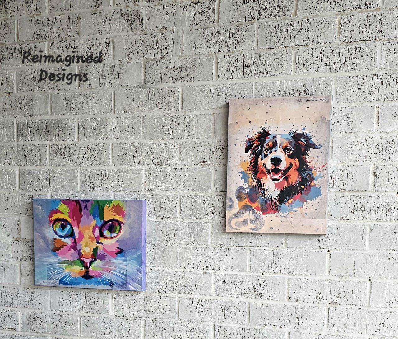 Two colorful animal portraits hang on a white textured brick wall. The left painting depicts a vibrant, abstract cat in shades of purple, blue, and green. The right painting features a lively, multicolored dog. A "Reimagined Designs" logo is on the upper left corner.