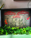 Dark brown chalk painted wood serving tray. Moonlit Mushrooms Stencil applied on the base of the tray with white stems and red caps as well as green leaves and orangish red flowers.