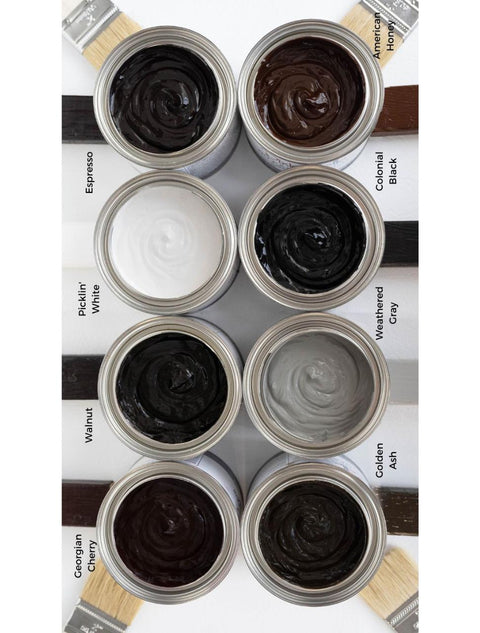 Dixie Belle Paint No Pain Gel Stain (Oil-Based) is available in eight wood enhancing colors! Top view of all 8 gel stains with swatches and paint brushes around them.
Left row: Georgian Cherry, Walnut, Picklin' White, Espresso
Right row: Golden Ash, Weathered Gray, Colonial Black, American Honey