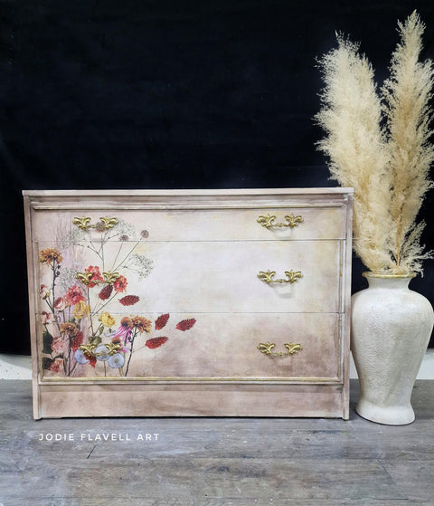 Beige and white dresser completed with the wildflowers design of this transfer applied to the front left.