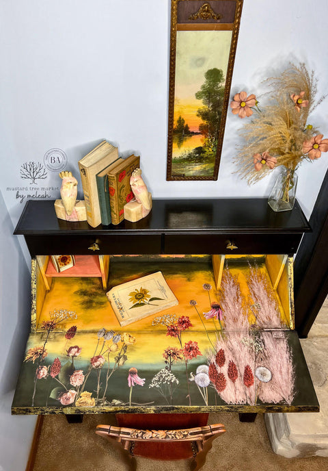 Black, yellow, pink, green, and blue chalk painted desk that opens. The Pink Pampas and Dried Wilds Transfer has been applied on the desk surface and the door at that opens.