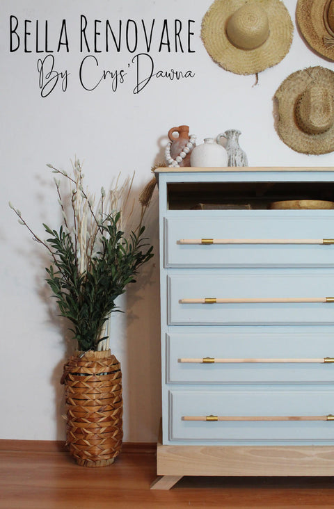 Silk All-In-One Mineral Paint Bay Breeze Silk Paint  is perfect for painting kitchen cabinets, bathroom cabinets and painting furniture.
Tall dresser painted in Bay Breeze Silk Paint with natural wood with gold accent hardware. Staged next to tall woven vase with greenery and straws inside.