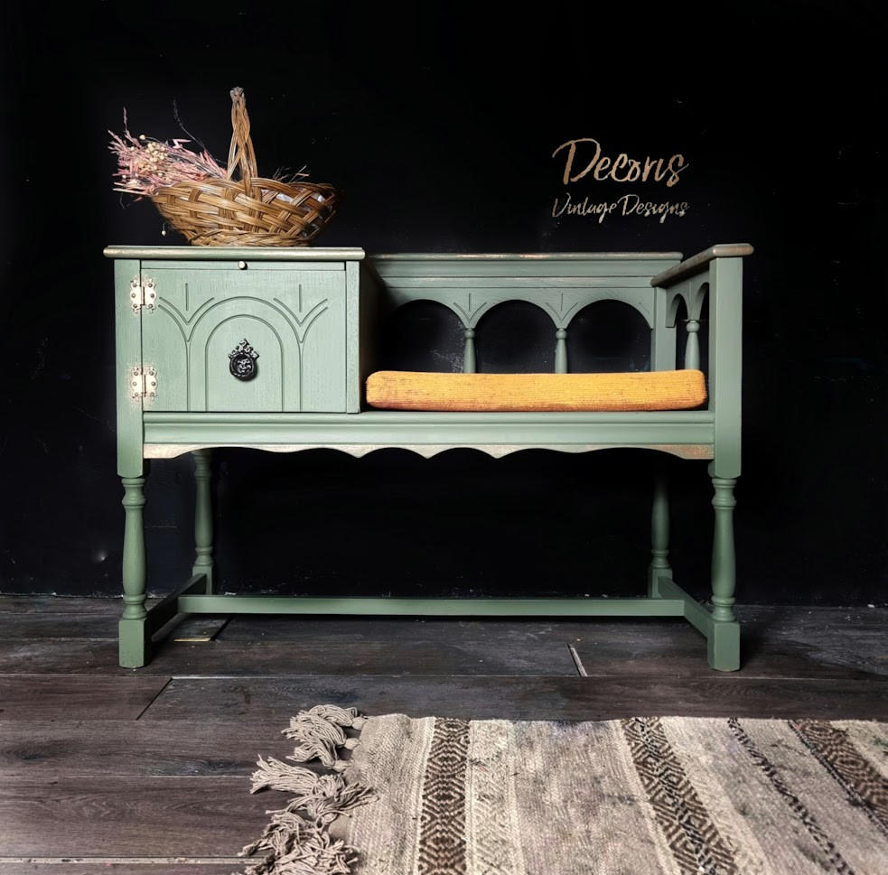 Cactus Silk All-In-One paint is perfect for painting kitchen cabinets, bathroom cabinets and painting furniture.
An entryway bench with storage painted in Cactus Silk All-In-One Mineral Paint® with a mustard yellow cushion and a woven basket stage on top of the drawer. Staged against a black wall.