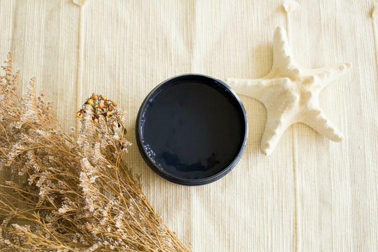 Deep Sea Silk All-In-One paint is perfect for painting kitchen cabinets, bathroom cabinets and painting furniture.
In this picture you are staring straight down on the paint.  There's a white starfish on the tan fabric that everything is resting on.  There is dried wheat to the left of the paint.