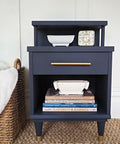 Deep Sea Silk All-In-One paint is perfect for painting kitchen cabinets, bathroom cabinets and painting furniture.
This is a night stand painted in Deep Sea Silk all in one mineral paint.  There's a gold handle to open the draw.  Below the drawer is an open area that has several, hard cover books.  On top of the books there's a white, ceramic, long and low vase.  on top of the drawer is an old fashioned, low, wide, white flower vase and an old fashioned alarm clock.  