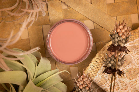 Desert Rose Silk All-In-One paint is perfect for painting kitchen cabinets, bathroom cabinets and painting furniture
This is a picture of the Desert Rose Silk All-In-One paint taken looking directly down on the paint.  Around the paint container are dried leaves and flowers.  It all rests on a wicker mate.  There is a piece of burlap under a dried flower.  The burlap has some white stenciling on top.