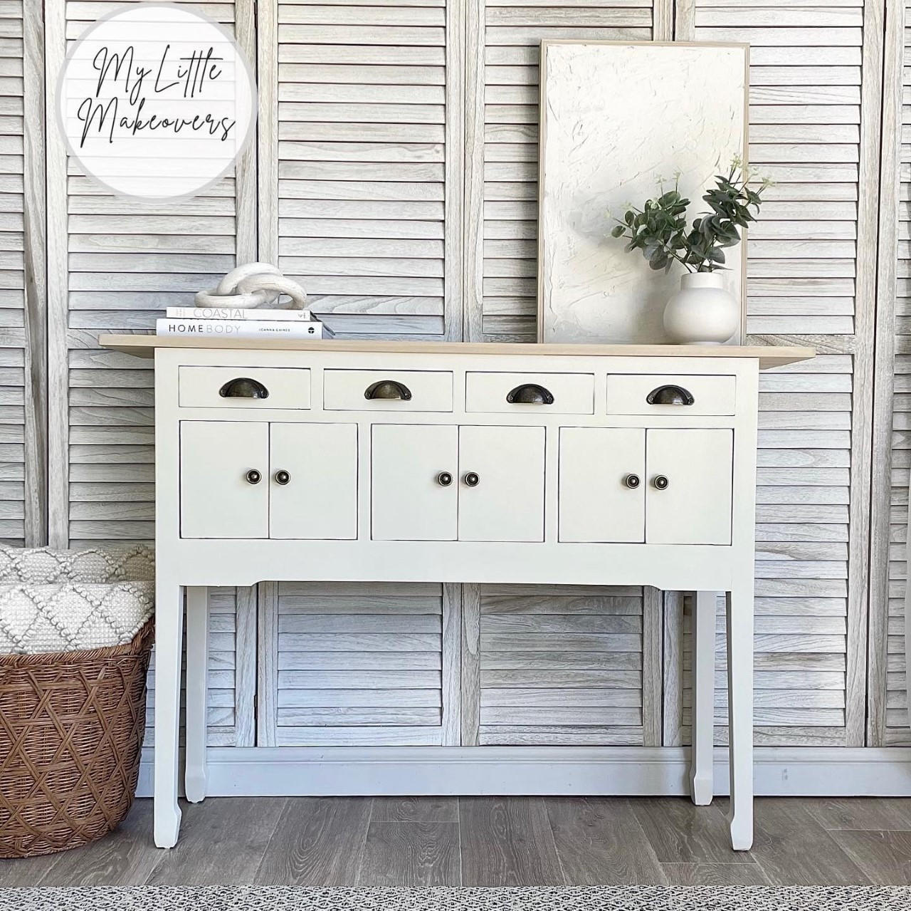 Endless Shore Silk All-In-One paint is perfect for painting kitchen cabinets, bathroom cabinets and painting furniture. White painted table makeover with black handles and a natural wood top. Staged with 2 white books on top and a white vase with faux greenery inside.