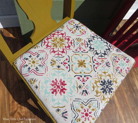 Fiery Sky Silk All-In-One paint is perfect for painting kitchen cabinets, bathroom cabinets and painting furniture.
An image of a chair and the cushion with the Sonoma Art Tile Stencil with the Fiery Sky Silk All-In-One paint as an accent with gold,blue and black along with it.