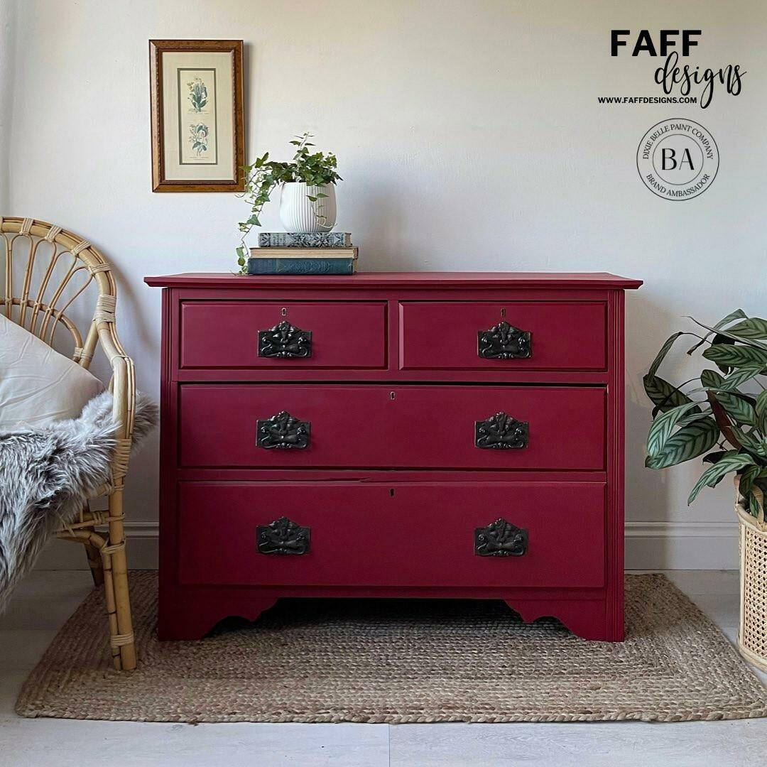Fiery Sky Silk All-In-One paint is perfect for painting kitchen cabinets, bathroom cabinets and painting furniture.
Dresser painted in Fiery Sky Silk All-In-One paint with black hardware. Staged with books stacked on eachother and a potted plant on top the piece.
