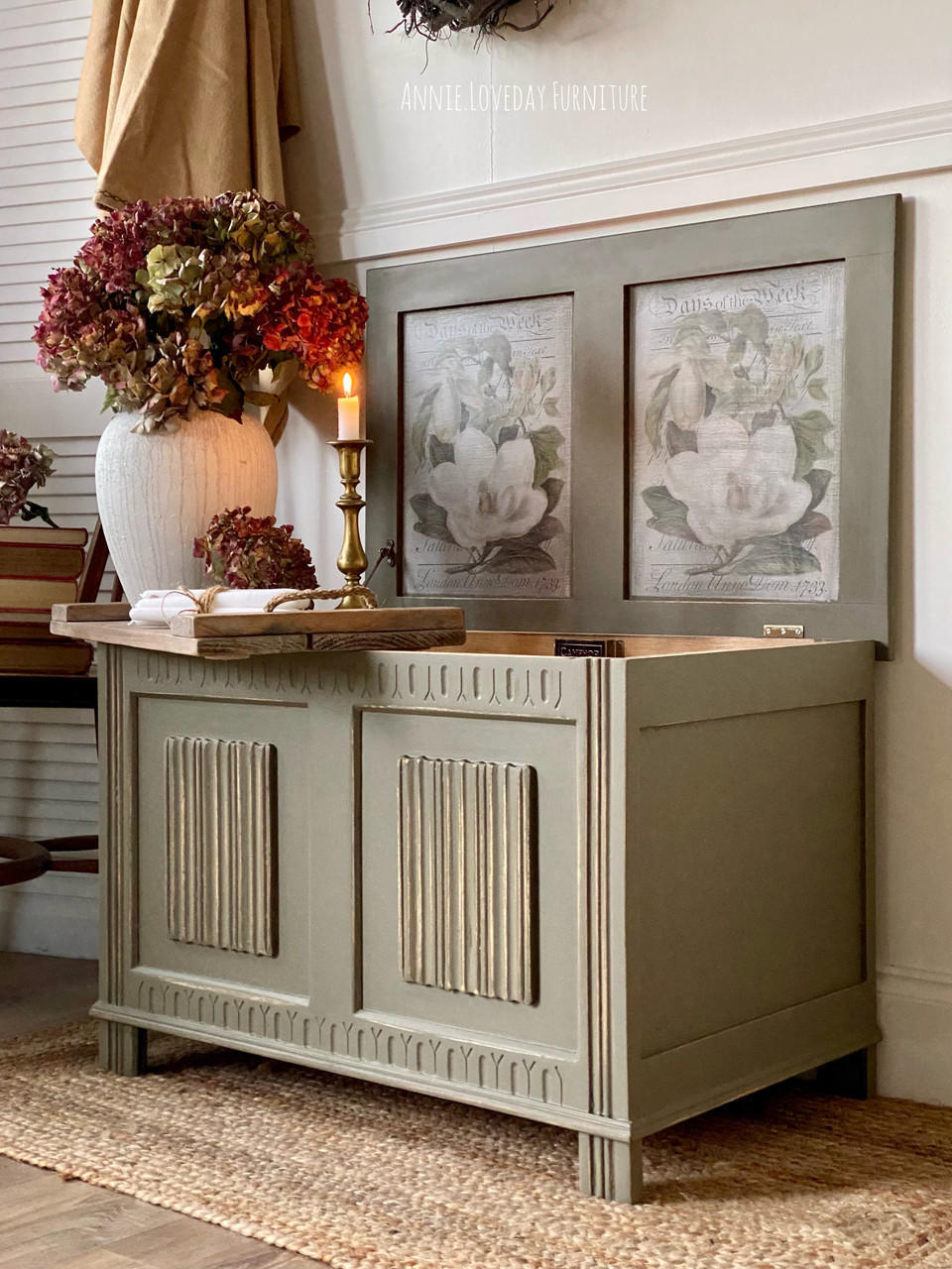 Hampton Olive Silk All-In-One paint is perfect for painting kitchen cabinets, bathroom cabinets and painting furniture.
Chest painted in Hampton Olive Silk All-In-One paint with the top lip open with the Magnolia Garden - Transfer on the inside panel. Staged with a tray that has a lit candle on a candle holder and a vase with flowers.