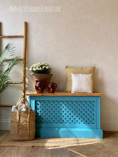 Harbor Silk All-In-One paint is perfect for painting kitchen cabinets, bathroom cabinets and painting furniture.
Chest painted in Harbor Silk All-In-One paint with a natural wood top staged with a tan and white pillows on the right and ceramic pots and pitchers to the left side on the piece of furniture.