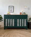 Midnight Green Silk All-In-One paint is perfect for painting kitchen cabinets, bathroom cabinets and painting furniture. Dark green Silk all in one painted hutch with stencil painted white on the doors. Staged with books, candles a terra pitcher and potted trailing ivy.