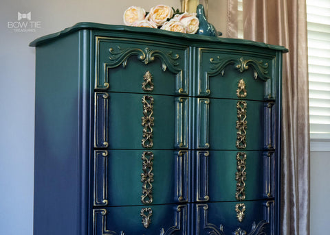 Midnight Green Silk All-In-One paint is perfect for painting kitchen cabinets, bathroom cabinets and painting furniture. Dark green and Blue Ombre painted dresser with gold accents on the scrolls. Staged with some white roses on top.