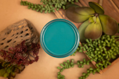 Mirage Silk All-In-One paint is perfect for painting kitchen cabinets, bathroom cabinets and painting furniture. Top View of Mirage staged with succulents and wood around it.