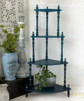 Mirage Silk All-In-One paint is perfect for painting kitchen cabinets, bathroom cabinets and painting furniture. Blue Green Silk All-In-One paint plant stand with Gold accents on the legs. Staged with a black trunk and potted plants.