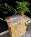 Mojave Silk All-In-One paint is perfect for painting kitchen cabinets, bathroom cabinets and painting furniture. Yellow Silk painted wicker end table with a colorful decoupage paper on top. Staged with potted ferns.