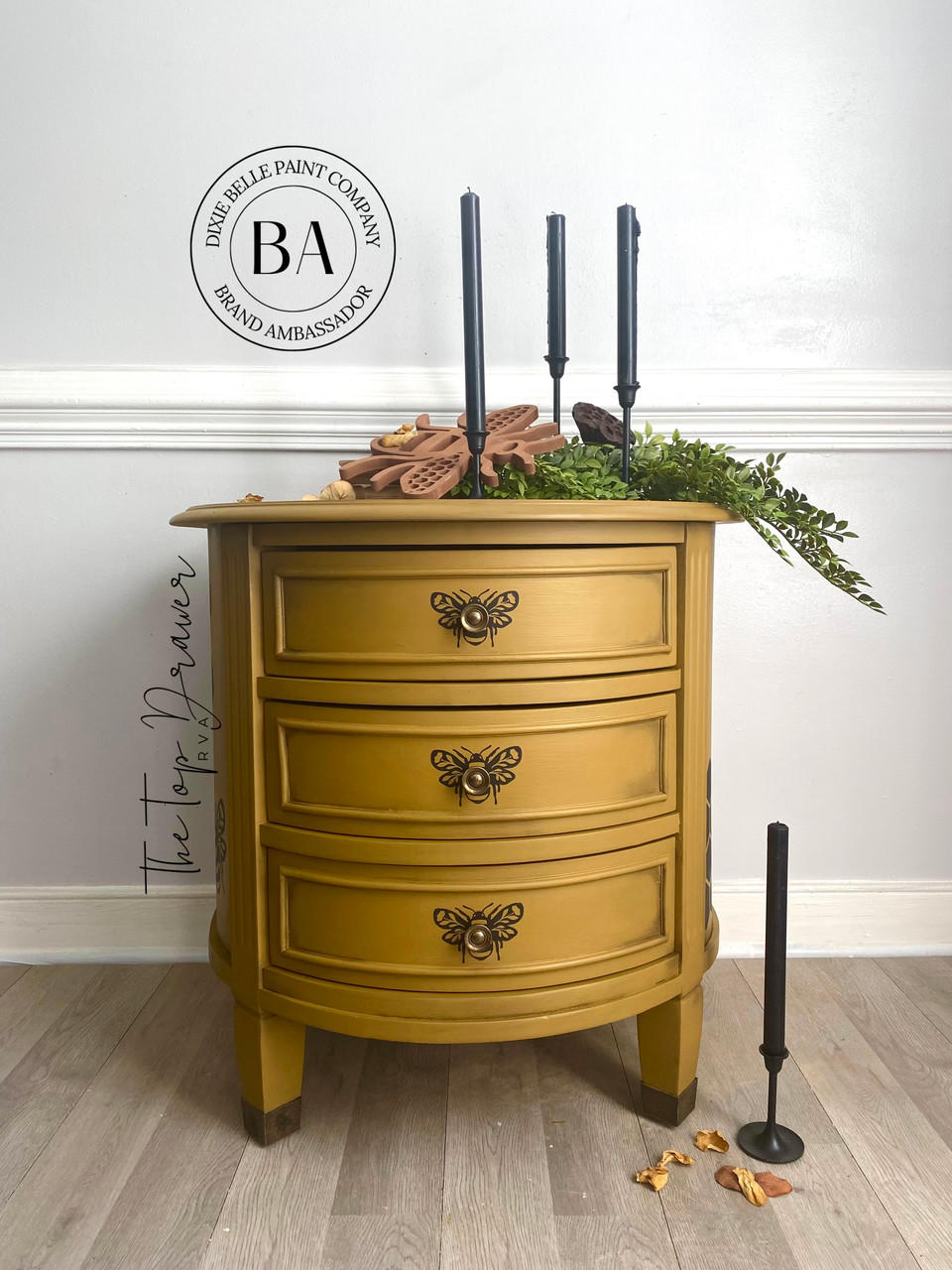 Mojave Silk All-In-One paint is perfect for painting kitchen cabinets, bathroom cabinets and painting furniture. Yellow painted end table with black bee stencils painted on. Staged with black candles, greenery and a bee décor.