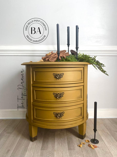Mojave Silk All-In-One paint is perfect for painting kitchen cabinets, bathroom cabinets and painting furniture. Yellow painted end table with black bee stencils painted on. Staged with black candles, greenery and a bee décor.