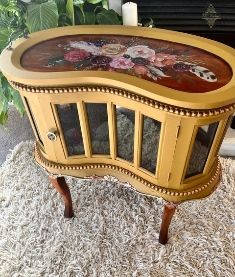 Mojave Silk All-In-One paint is perfect for painting kitchen cabinets, bathroom cabinets and painting furniture. yellow drink cabinet with wood stained top and legs and floral rub on transfers on the top.