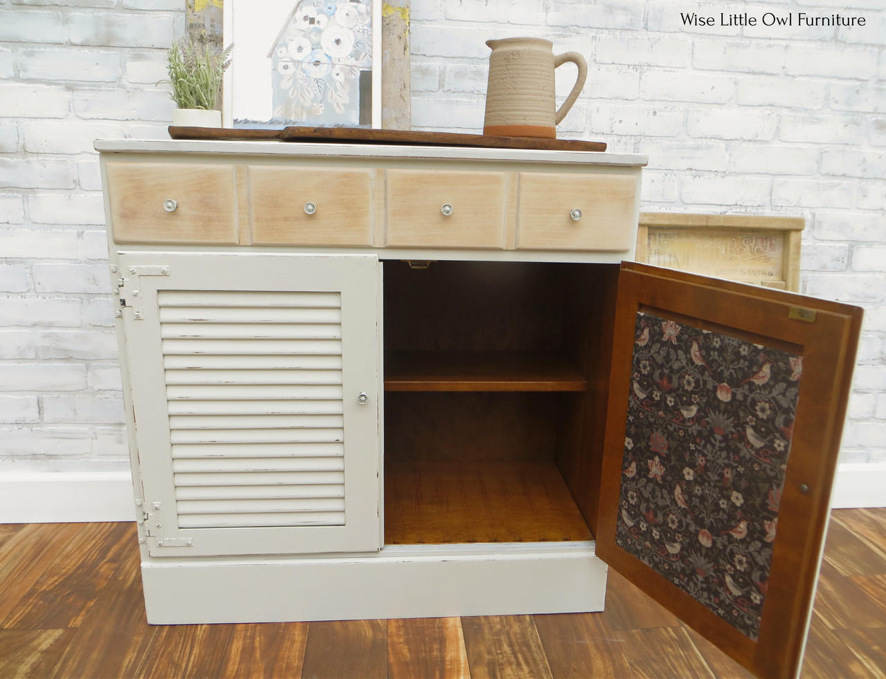 Oyster Silk All-In-One paint is perfect for painting kitchen cabinets, bathroom cabinets and painting furniture. White  Silk All-In-One painted cabinet with bird decoupage on the inside of the door. Staged with plants and a clay pitcher.