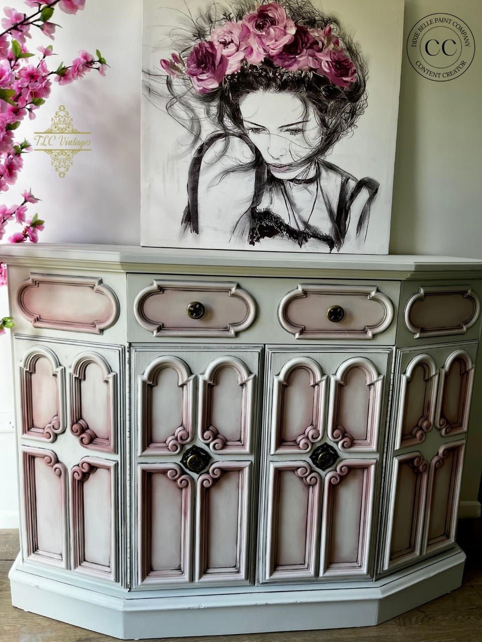 Oyster Silk All-In-One paint is perfect for painting kitchen cabinets, bathroom cabinets and painting furniture. White  Silk All-In-One painted side table with pink blended into the corners. Staged with a painting of a girl with pink flowers.