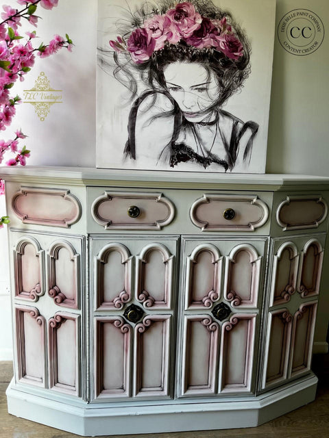 Oyster Silk All-In-One paint is perfect for painting kitchen cabinets, bathroom cabinets and painting furniture. White  Silk All-In-One painted side table with pink blended into the corners. Staged with a painting of a girl with pink flowers.