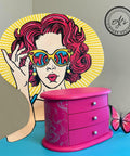 Prickly Pear Silk All-In-One paint is perfect for painting kitchen cabinets, bathroom cabinets and painting furniture. Pink chalk painted jewelry box with silver scroll detail painted on the side. Staged on a chair with a girl painted on in different colors.