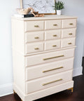 Sand Castle Silk All-In-One paint is perfect for painting kitchen cabinets, bathroom cabinets and painting furniture! A tall dresser painted in sand castle and has gold hardware. This dresser has 12 drawers, 9 small ones on the top half and 3 long ones on the bottom.