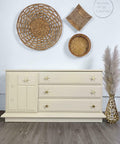 Sand Castle Silk All-In-One paint is perfect for painting kitchen cabinets, bathroom cabinets and painting furniture! A long dresser painted in sand castle with flower shaped hardware.