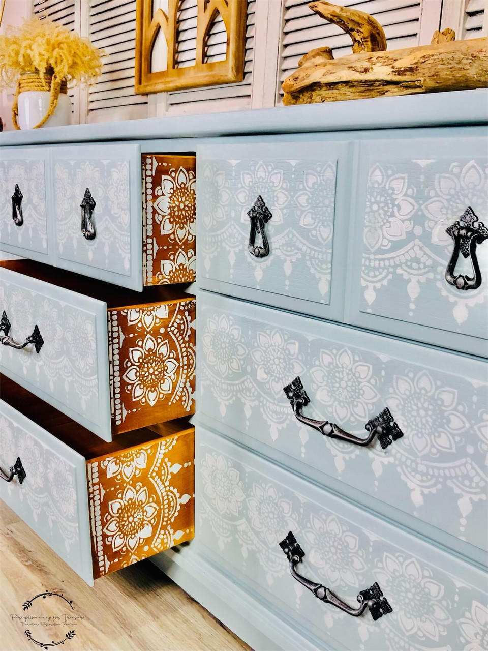 Serenity Silk All-In-One paint is perfect for painting kitchen cabinets, bathroom cabinets and painting furniture! A dresser painted in serenity and has a stencil in white on the front of the drawers and the inside of the drawers have a stencil that is also in serenity.