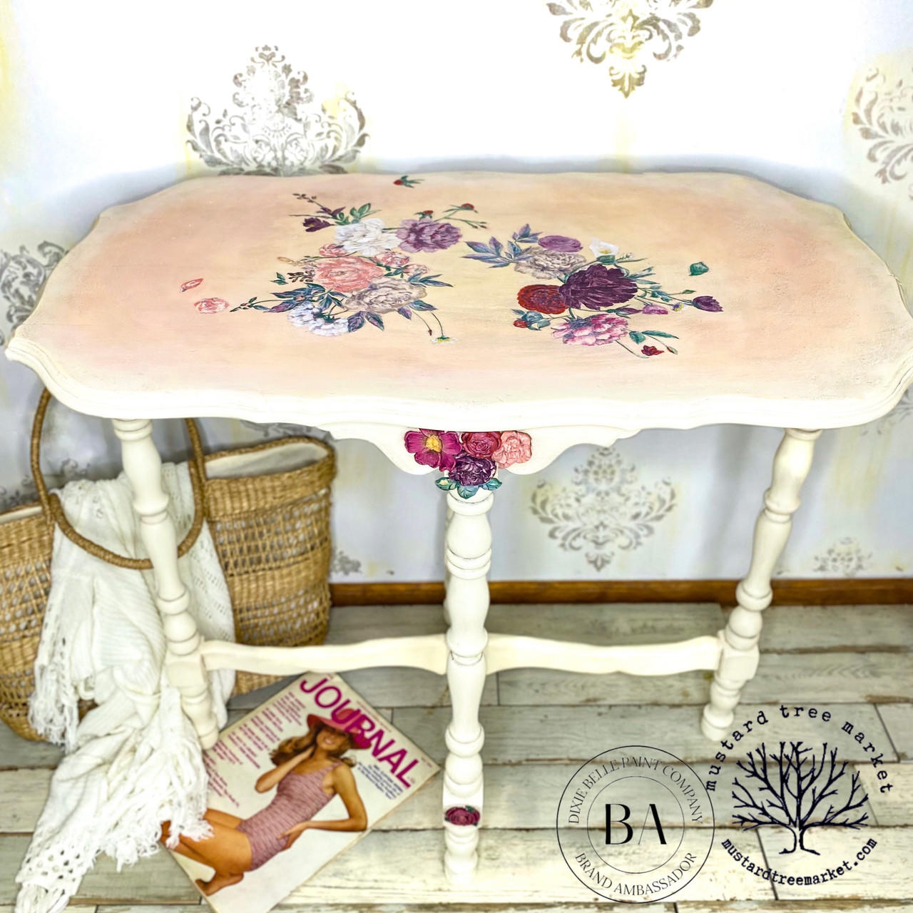 Sun Kissed Silk All-In-One paint is perfect for painting kitchen cabinets, bathroom cabinets and painting furniture.
console table painted in Sun Kissed Silk All-In-One paint  with the top blended with a pink and it has the Flower Child - Transfer on the top of the table. Staged with a woven bag and magazine under the table.